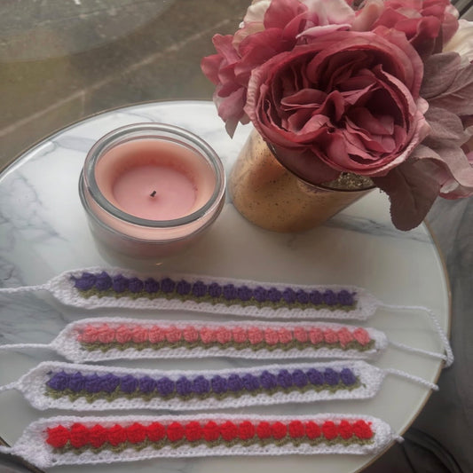 Crochet bookmarks with a row of tulips in purple, coral and red on white